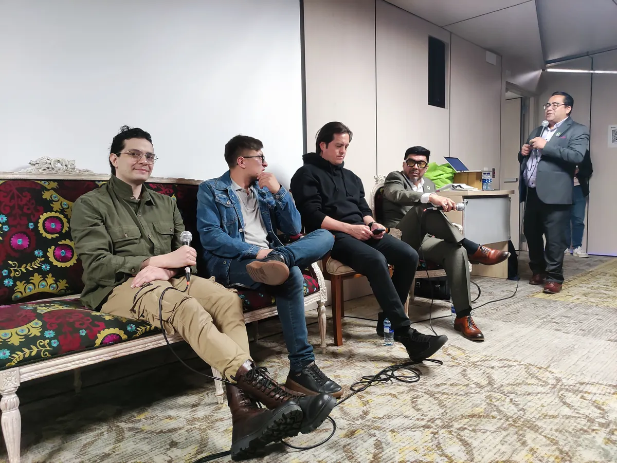 Moderator standing while addressing the panel.