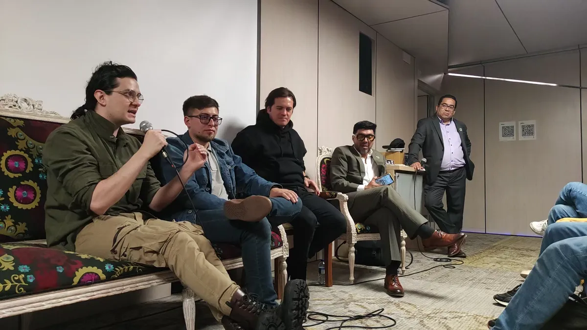 Luis Alberto Duarte Cortés speaking on the panel, microphone in hand.